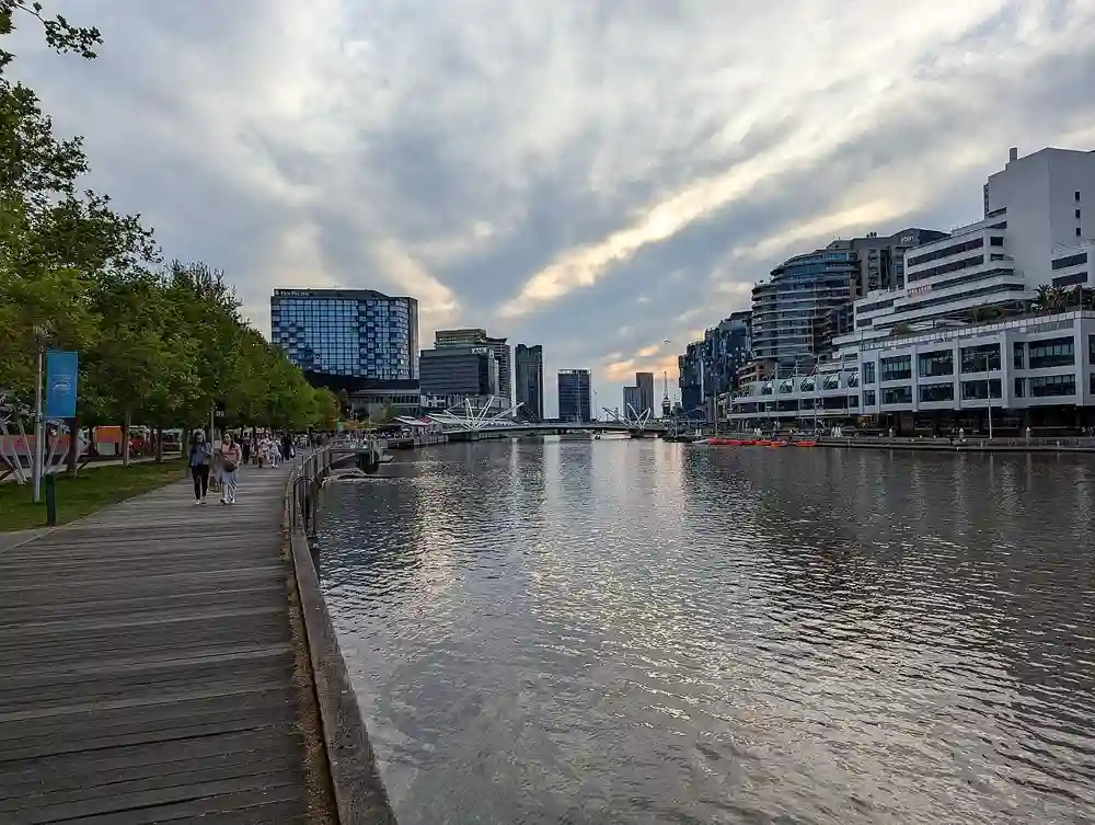 The riverside boardwalk at South Wharf Promenade on the Yarra River at dusk