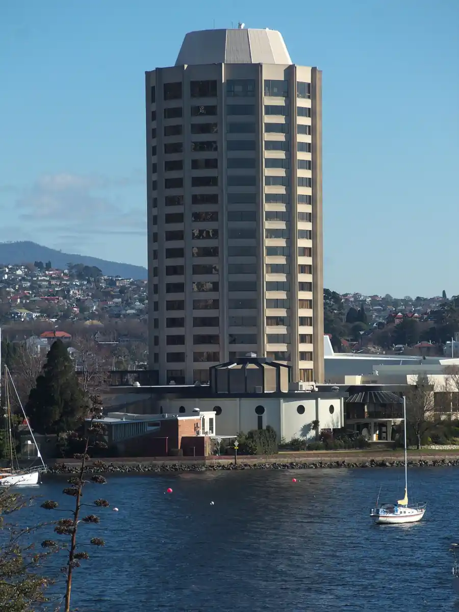 The Wrest Point hotel tower seen across the water at Sandy Bay, with a yacht moored in front